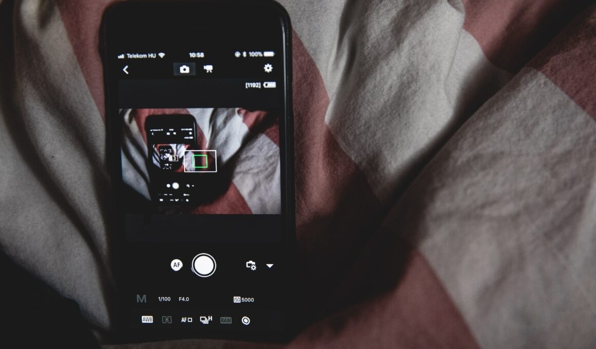 black Android smartphone on bed sheet